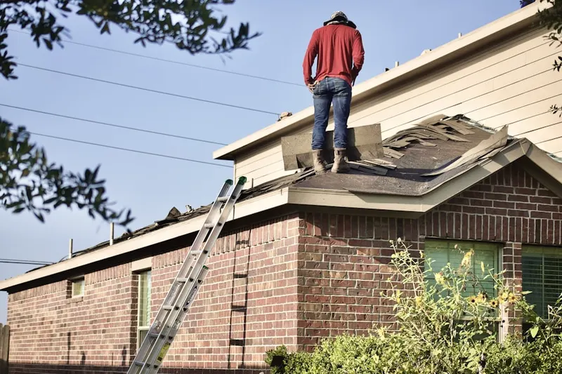 Professional roofer working on a residential roof in College Estates